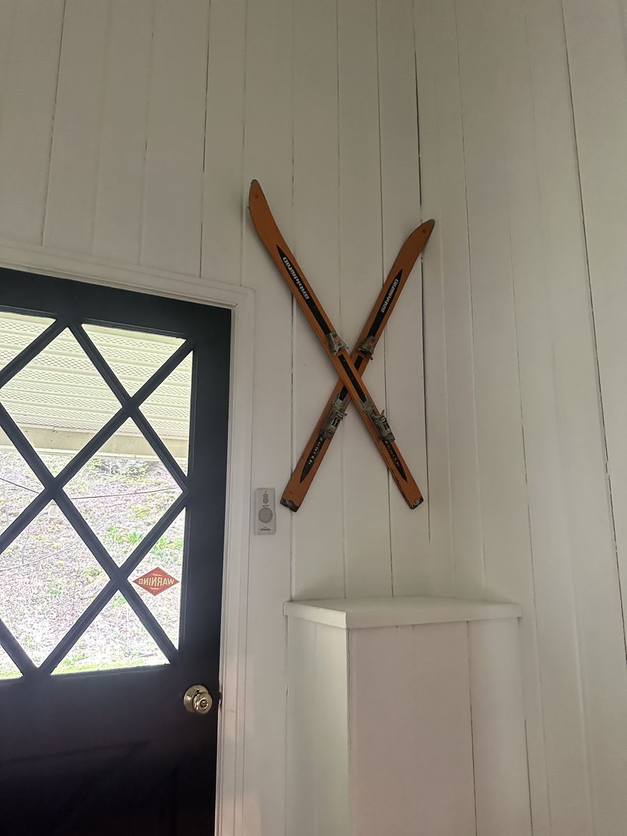 Vintage wooden skis mounted above the front entryway